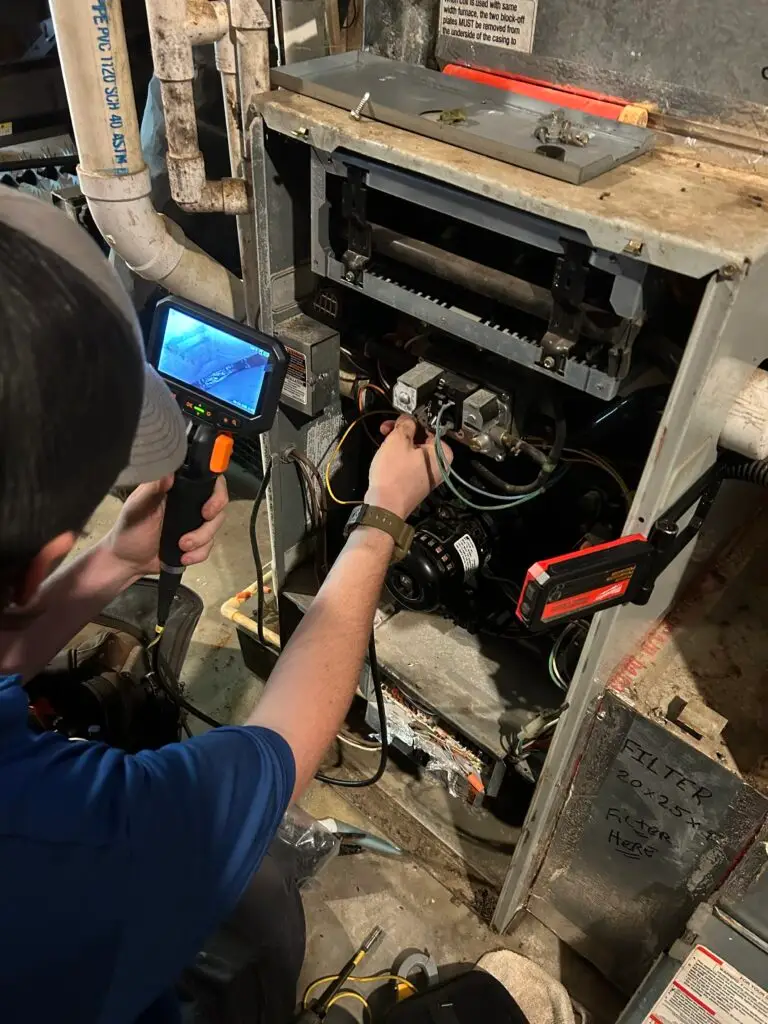 HVAC Technician Inspection and testing basement furnace